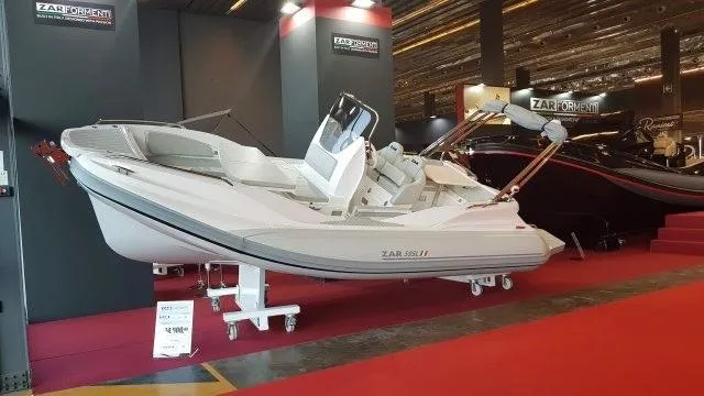 Slide: The Image of 2022 Zar Formenti 59 SL boat displayed at an indoor boat show. - 6