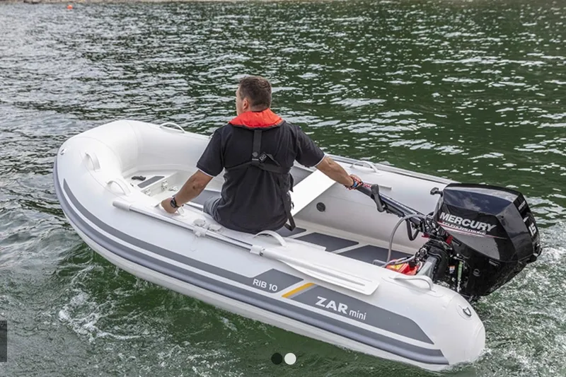Slide: The Image of 2022 ZAR Mini RIB 8 HDL inflatable boat with Mercury outboard motor on water. - 6