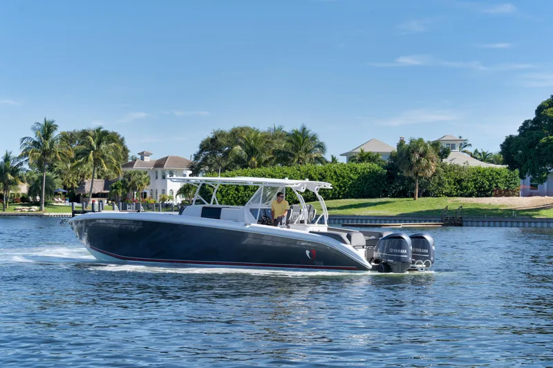 Slide: The Image of 2016 Powerplay Powerboats 42 cruising on a sunny day near waterfront homes. - 11