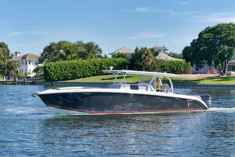 Slide: The Image of 2016 Powerplay Powerboats 42 cruising on a sunny day near waterfront homes. - 14