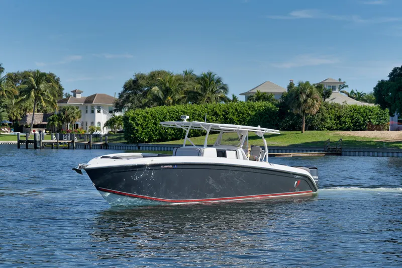 Slide: The Image of 2016 Powerplay Powerboats 42 cruising on a sunny day near waterfront homes. - 15