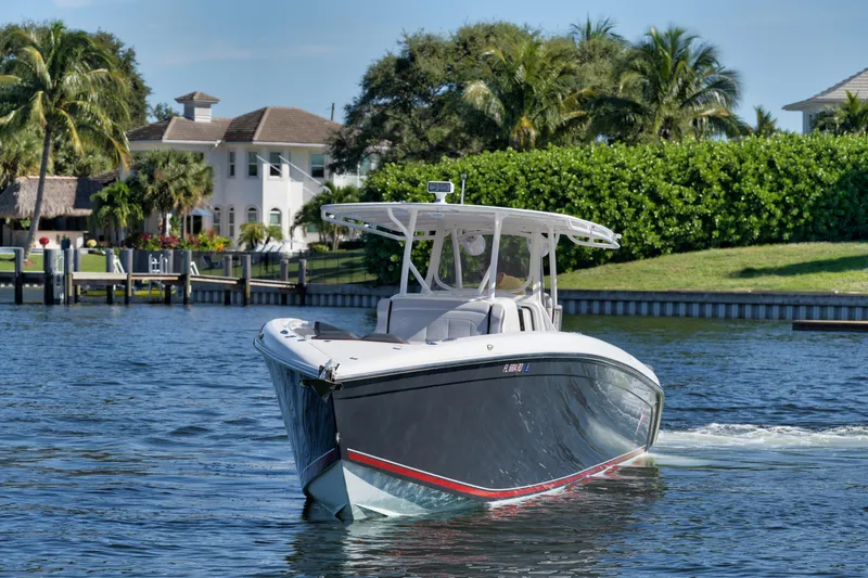 Slide: The Image of 2016 Powerplay Powerboats 42 model cruising on a scenic waterway. - 16