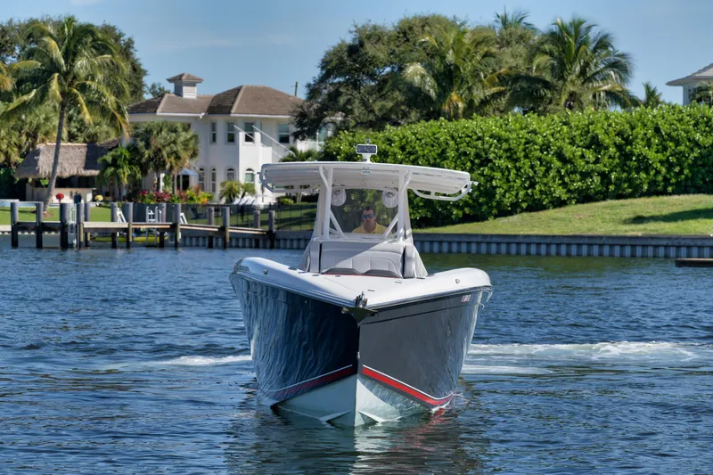 Slide: The Image of 2016 Powerplay Powerboats 42 cruising on a sunny day near waterfront homes. - 17