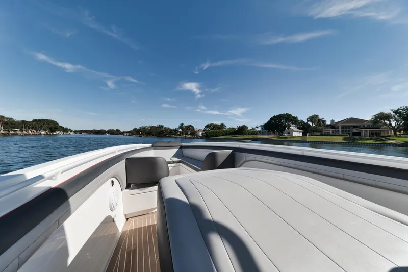 Slide: The Image of 2016 Powerplay Powerboats 42 on a serene lake with clear skies. - 18