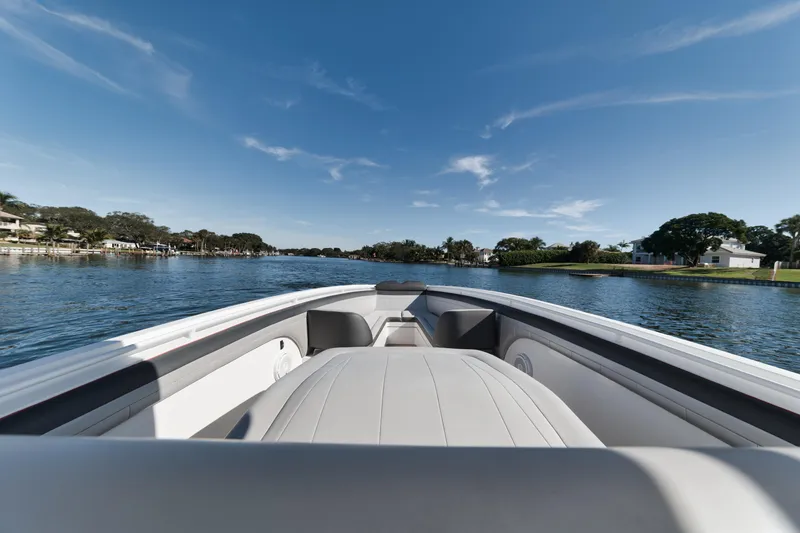 Slide: The Image of 2016 Powerplay Powerboats 42 on a serene lake with clear blue skies. - 19