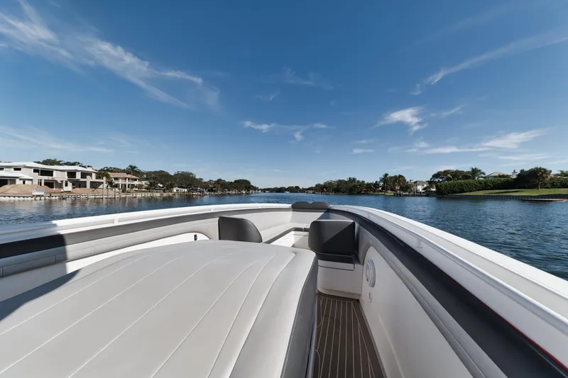 Slide: The Image of 2016 Powerplay Powerboats 42 on a serene waterway with clear skies. - 22