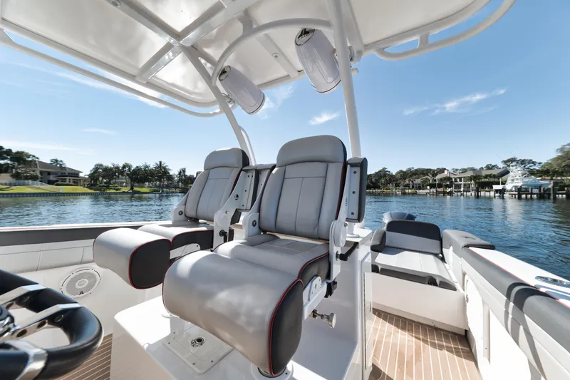 Slide: The Image of 2016 Powerplay Powerboats 42 model with luxurious seating on a sunny day. - 30