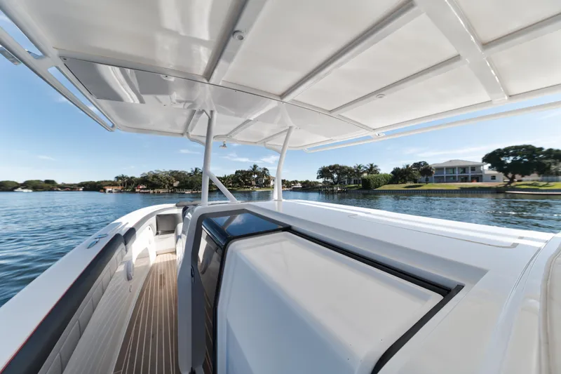Slide: The Image of 2016 Powerplay Powerboats 42 on a serene lake with waterfront homes. - 33