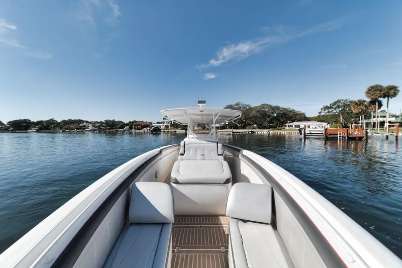 Slide: The Image of 2016 Powerplay Powerboats 42 on a serene lake with clear skies. - 39