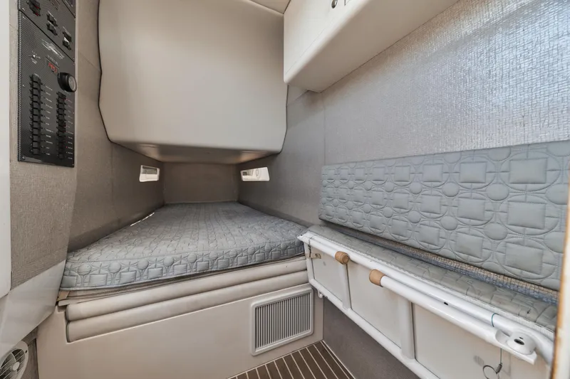 Slide: The Image of 2016 Powerplay Powerboats 42 cabin interior with bed and storage compartments. - 43