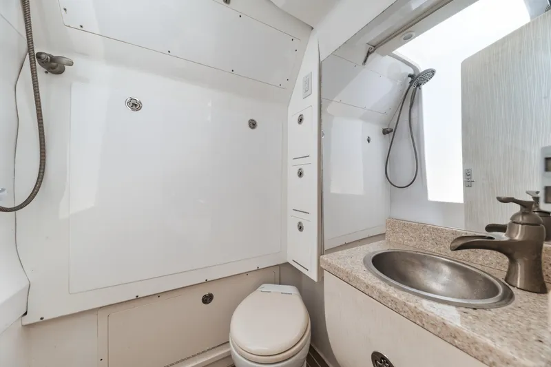 Slide: The Image of 2016 Powerplay Powerboats 42 bathroom with shower, sink, and toilet. - 46