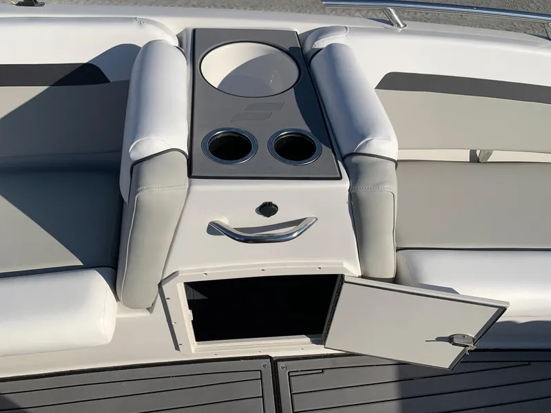 Slide: The Image of 2024 Starcraft SVX 211 boat interior with cup holders and storage compartment. - 11