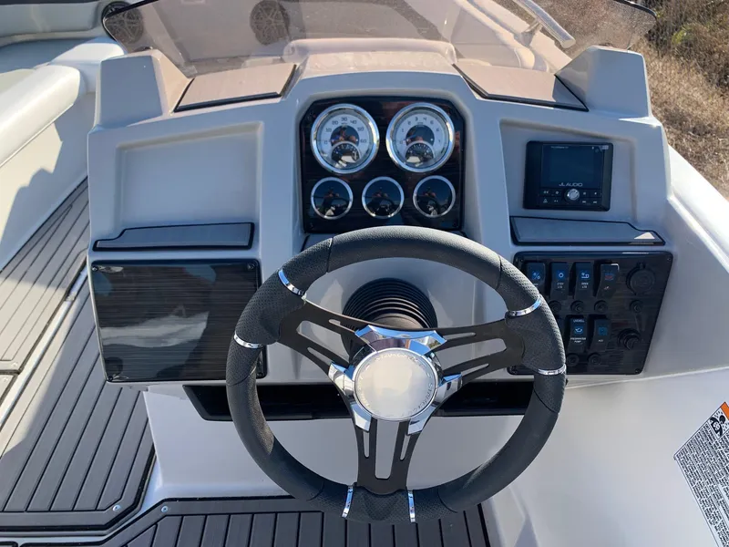Slide: The Image of 2024 Starcraft SVX 211 boat dashboard with steering wheel and instrument panel. - 13