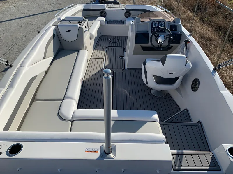Slide: The Image of 2024 Starcraft SVX 211 boat interior with spacious seating and modern helm. - 15