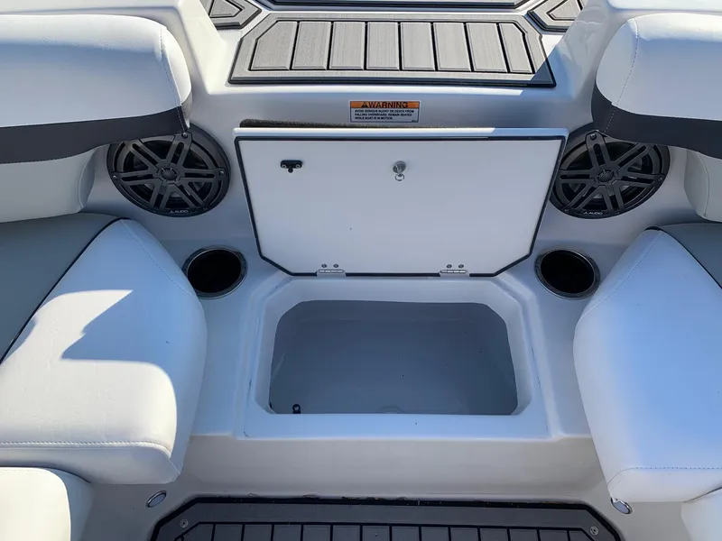 Slide: The Image of 2024 Starcraft SVX 211 boat interior with storage compartment and cup holders. - 9