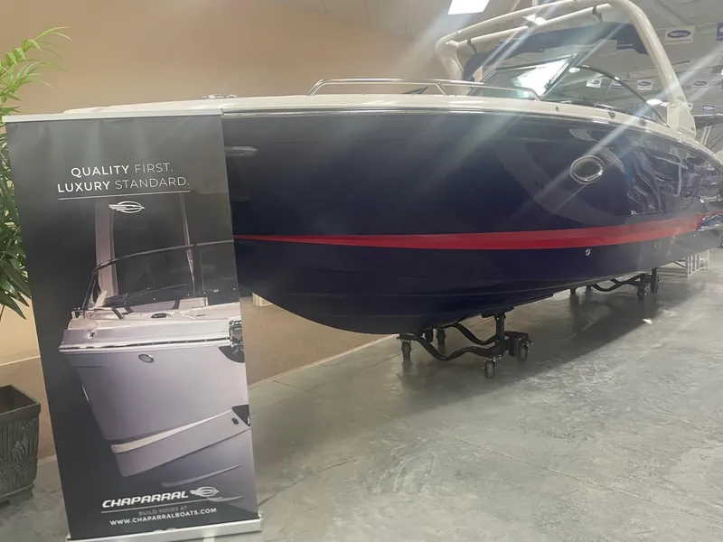 Slide: The Image of 2023 Chaparral 287 SSX boat in showroom, rear view. - 3