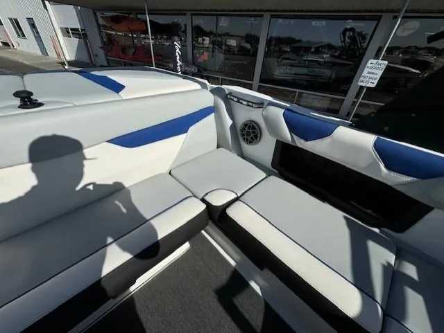 Slide: The Image of 2020 Axis A20 boat interior with white and blue seating, speaker, and shadow. - 13