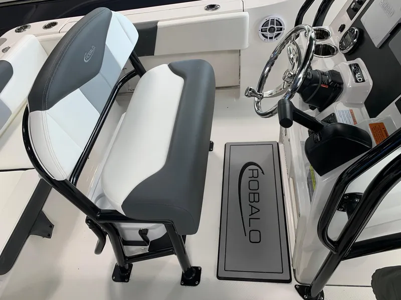 Slide: The Image of 2024 Robalo R202 Explorer boat interior with steering wheel and seating. - 12