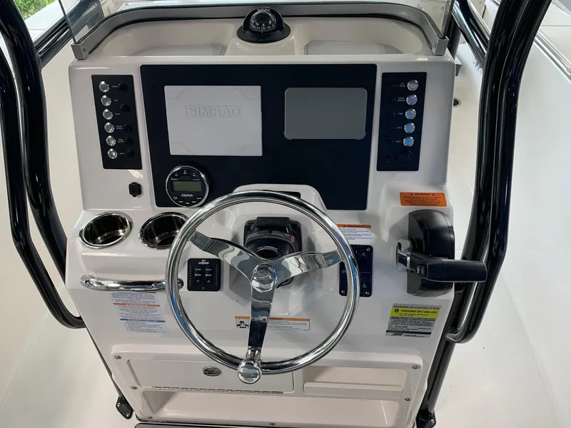 Slide: The Image of 2024 Robalo R202 Explorer boat console with steering wheel and control panel. - 13