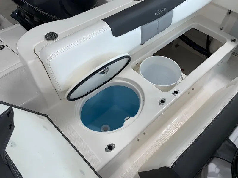 Slide: The Image of 2024 Robalo R202 Explorer boat interior with livewell and storage compartments. - 5