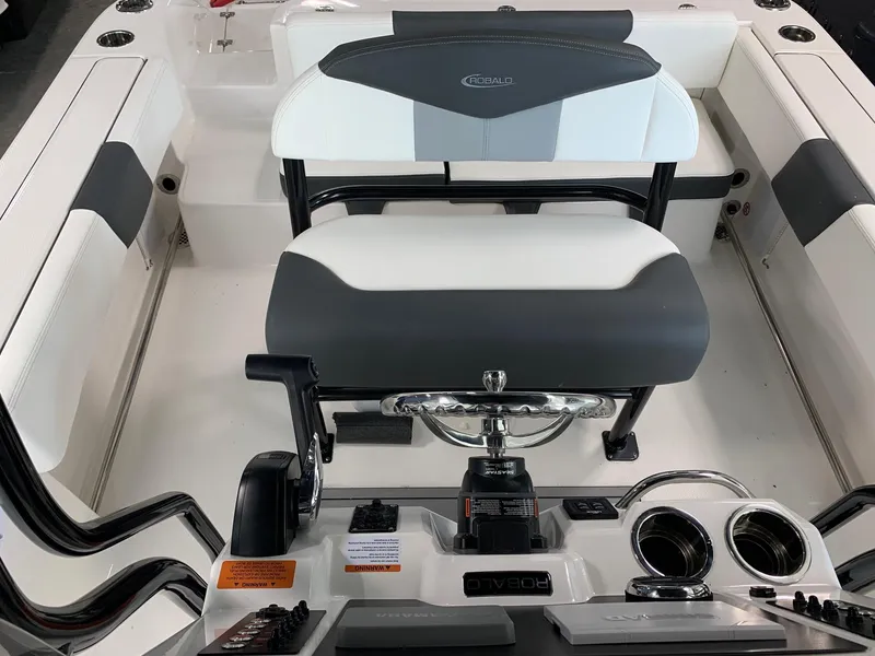 Slide: The Image of 2024 Robalo R202 Explorer boat interior with helm and seating. - 11