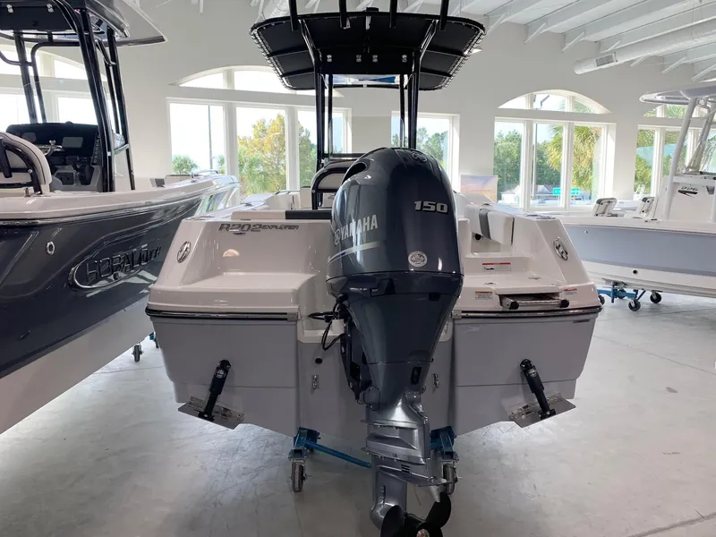 Slide: The Image of 2024 Robalo R202 Explorer boat with Yamaha 150 engine in showroom. - 2
