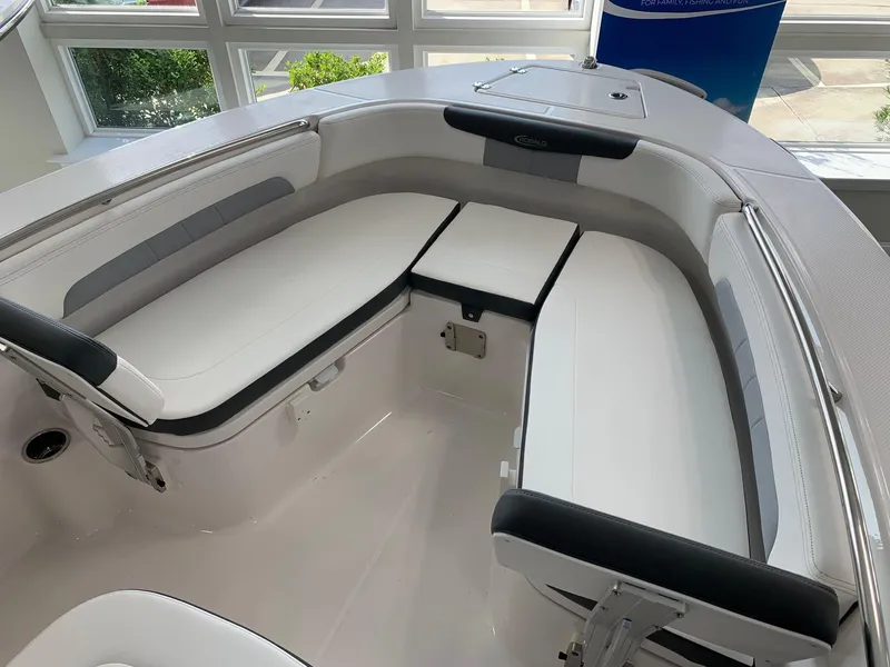 Slide: The Image of 2024 Robalo R202 Explorer boat interior with cushioned seating. - 6