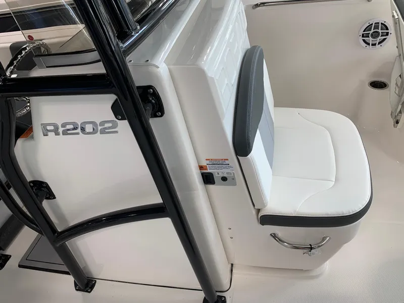 Slide: The Image of 2024 Robalo R202 Explorer boat interior with white seating and black accents. - 7