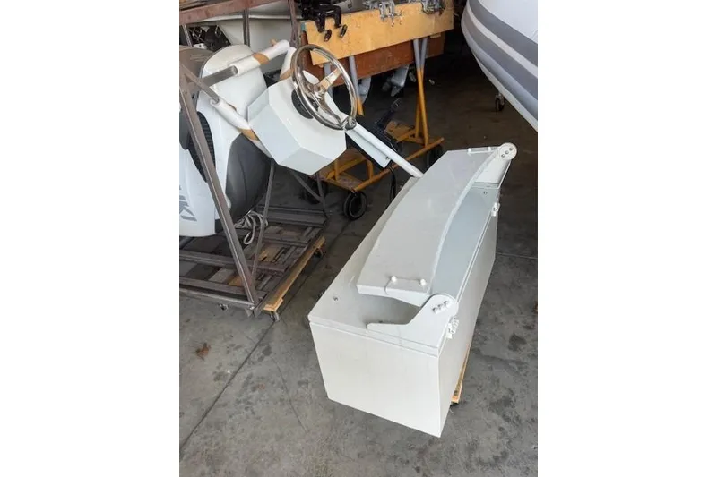 Slide: The Image of 2022 ZAR Mini RIB 14 HDL boat console and seat in a workshop setting. - 14