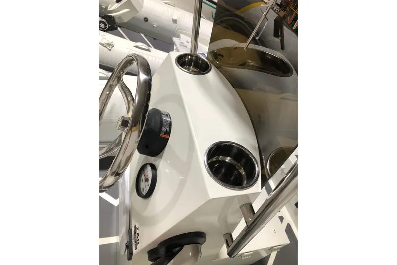 Slide: The Image of Steering console of 2022 ZAR Mini RIB 14 HDL with stainless steel wheel and cup holders. - 17