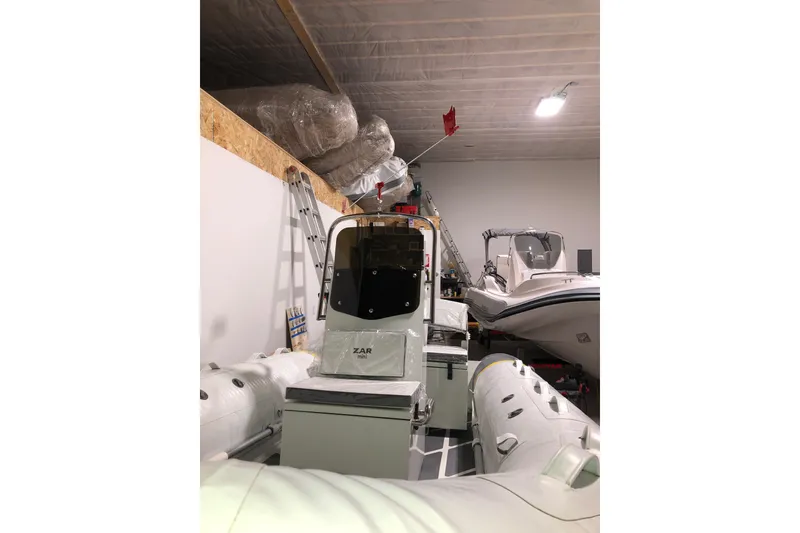 Slide: The Image of 2022 ZAR Mini RIB 14 HDL inflatable boat stored indoors with equipment. - 18