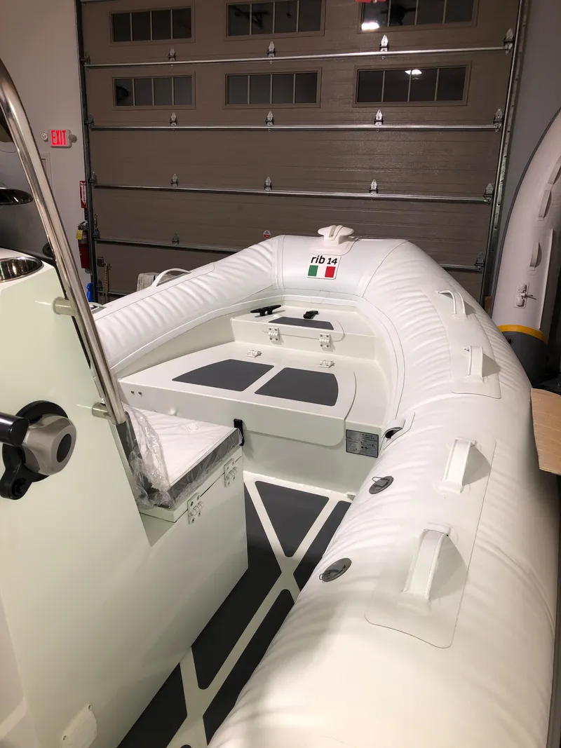 Slide: The Image of 2022 ZAR Mini RIB 14 HDL inflatable boat in a garage. - 2