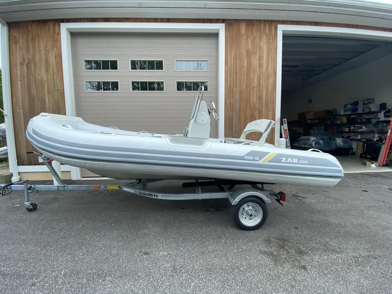 Slide: The Image of 2022 ZAR Mini RIB 15 HDL Tender 60 Hp on trailer outside garage. - 1