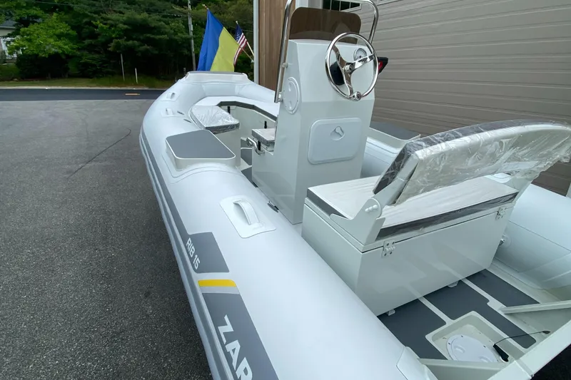 Slide: The Image of 2022 ZAR Mini RIB 15 HDL Tender 60 Hp inflatable boat, docked near a building. - 5