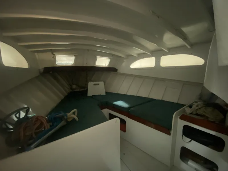 Slide: The Image of Interior of a 1960 Classic Riverside Boat Co. with green cushions and storage compartments. - 17