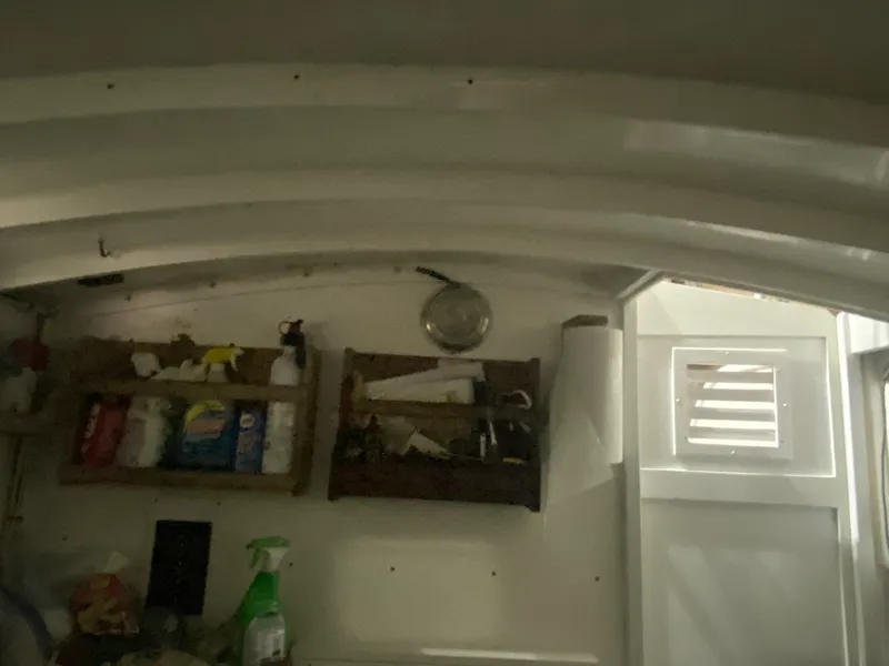 Slide: The Image of Interior of a 1960 Classic Riverside Boat Co. with shelves and cleaning supplies. - 18