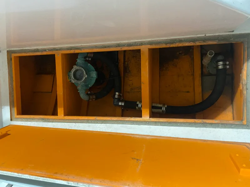 Slide: The Image of 1960 Classic Riverside Boat Co. engine compartment with visible hoses and components. - 23