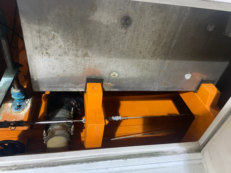Slide: The Image of 1960 Classic Riverside Boat Co. engine compartment with orange components and metal panel. - 25