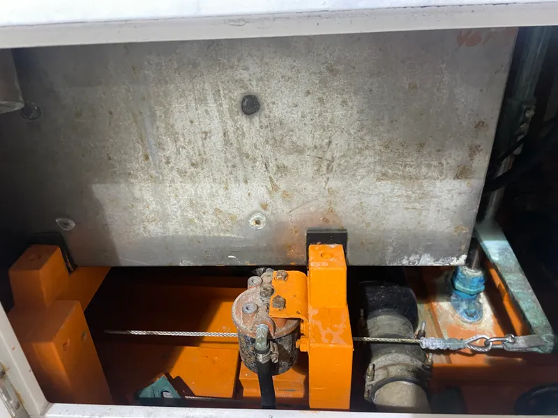 Slide: The Image of 1960 Classic Riverside Boat Co. engine compartment with orange components and metal cable. - 26