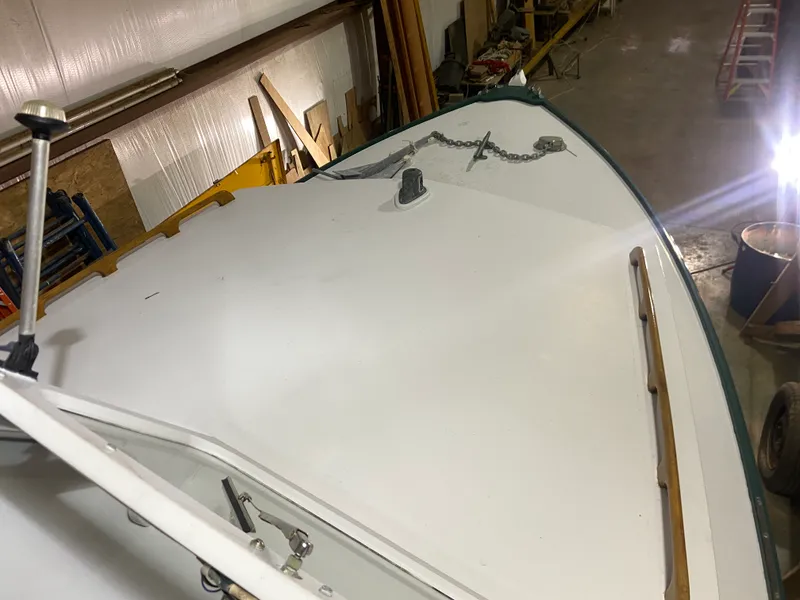 Slide: The Image of 1960 Classic Riverside Boat Co. deck in workshop, featuring anchor chain and wooden railings. - 28