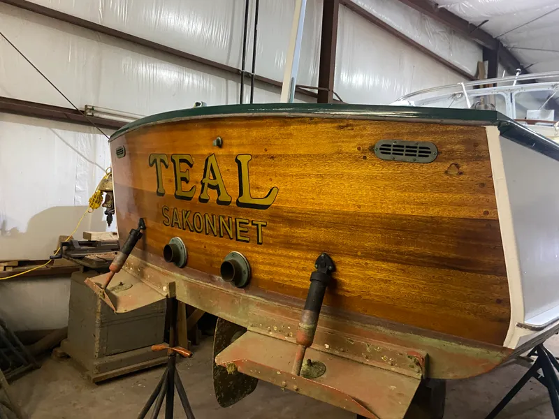 Slide: The Image of 1960 Classic Riverside Boat Co. "Teal Sakonnet" in storage, showcasing wooden craftsmanship. - 5