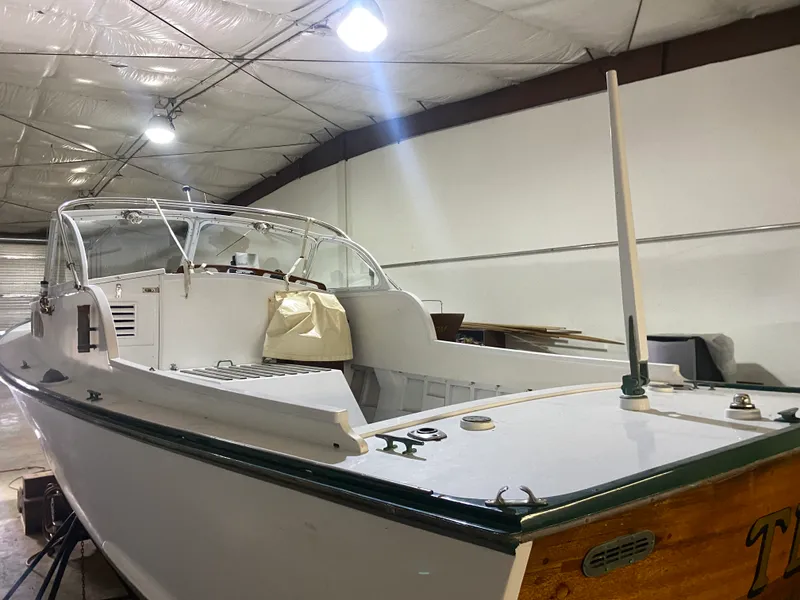 Slide: The Image of 1960 Classic Riverside Boat Co. model in a well-lit indoor storage facility. - 6