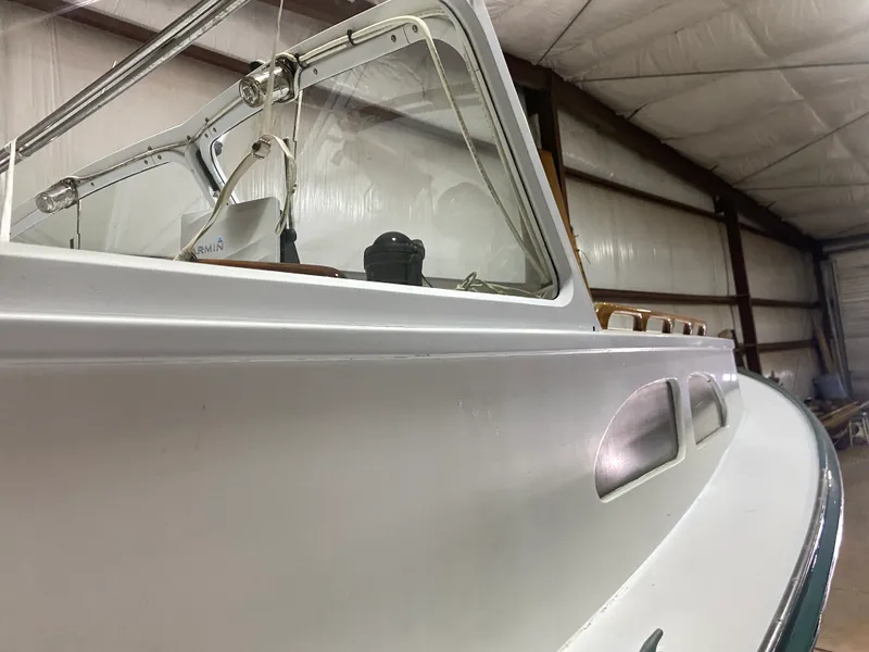 Slide: The Image of 1960 Classic Riverside Boat Co. vessel in a storage facility, showcasing sleek design and vintage charm. - 8