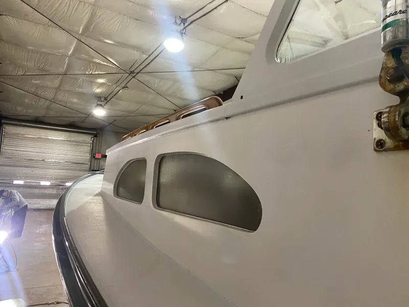 Slide: The Image of 1960 Classic Riverside Boat Co. vessel in a warehouse, showcasing vintage design and craftsmanship. - 9