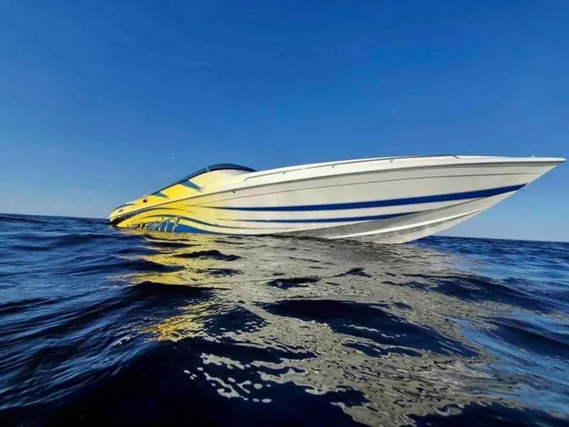The Image of 2024 Velocity 322SC speedboat on open water under clear blue sky. - 1