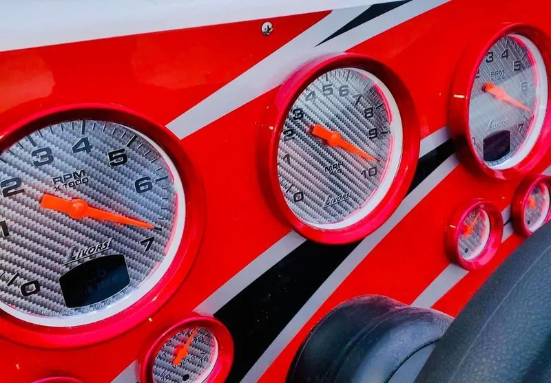 Slide: The Image of Close-up of 2024 Velocity 322SC dashboard with red and silver gauges. - 7