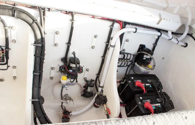 Slide: The Image of 2024 Velocity 322SC engine compartment with batteries and wiring. - 8