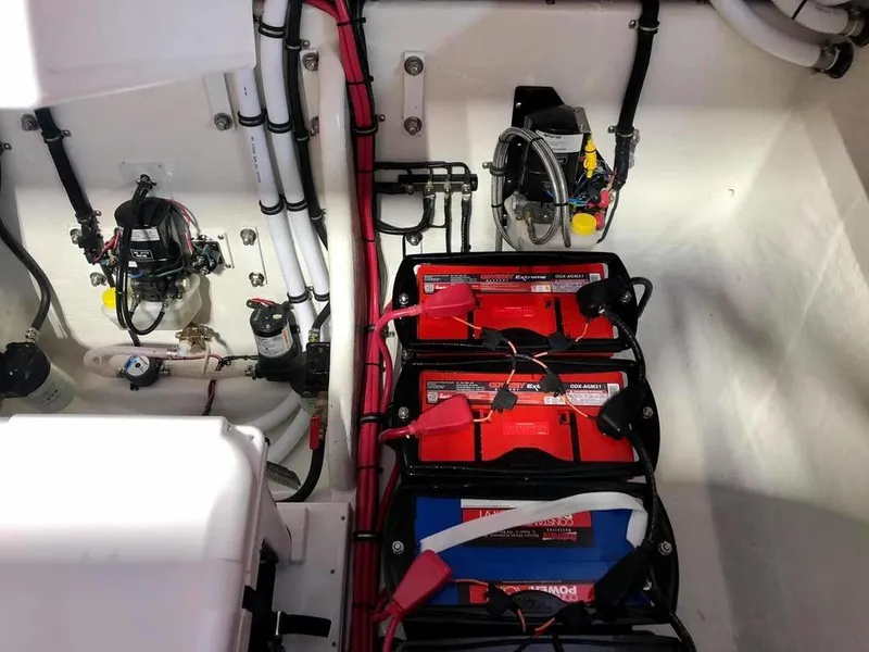 Slide: The Image of Battery compartment of 2024 Velocity 322SC boat with wiring and electrical components. - 9
