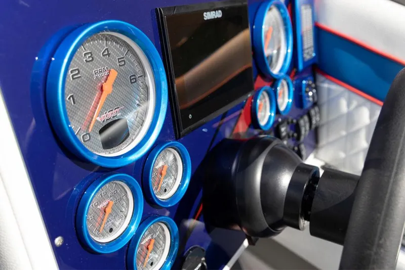 Slide: The Image of 2024 Velocity 260VR dashboard with gauges and Simrad display. - 10