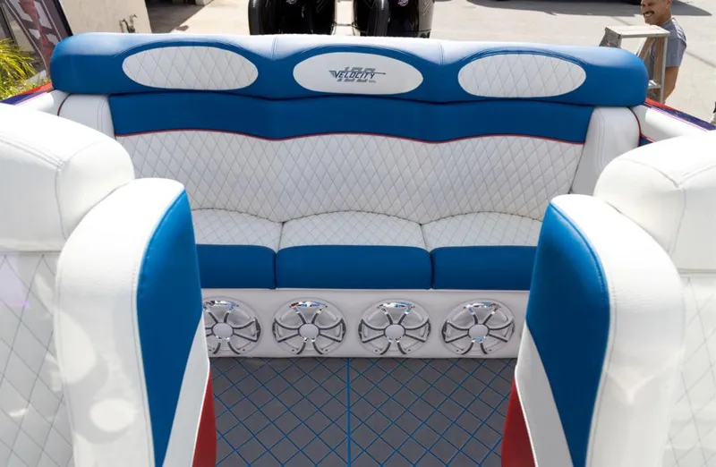Slide: The Image of 2024 Velocity 260VR boat interior with blue and white seating and built-in speakers. - 3